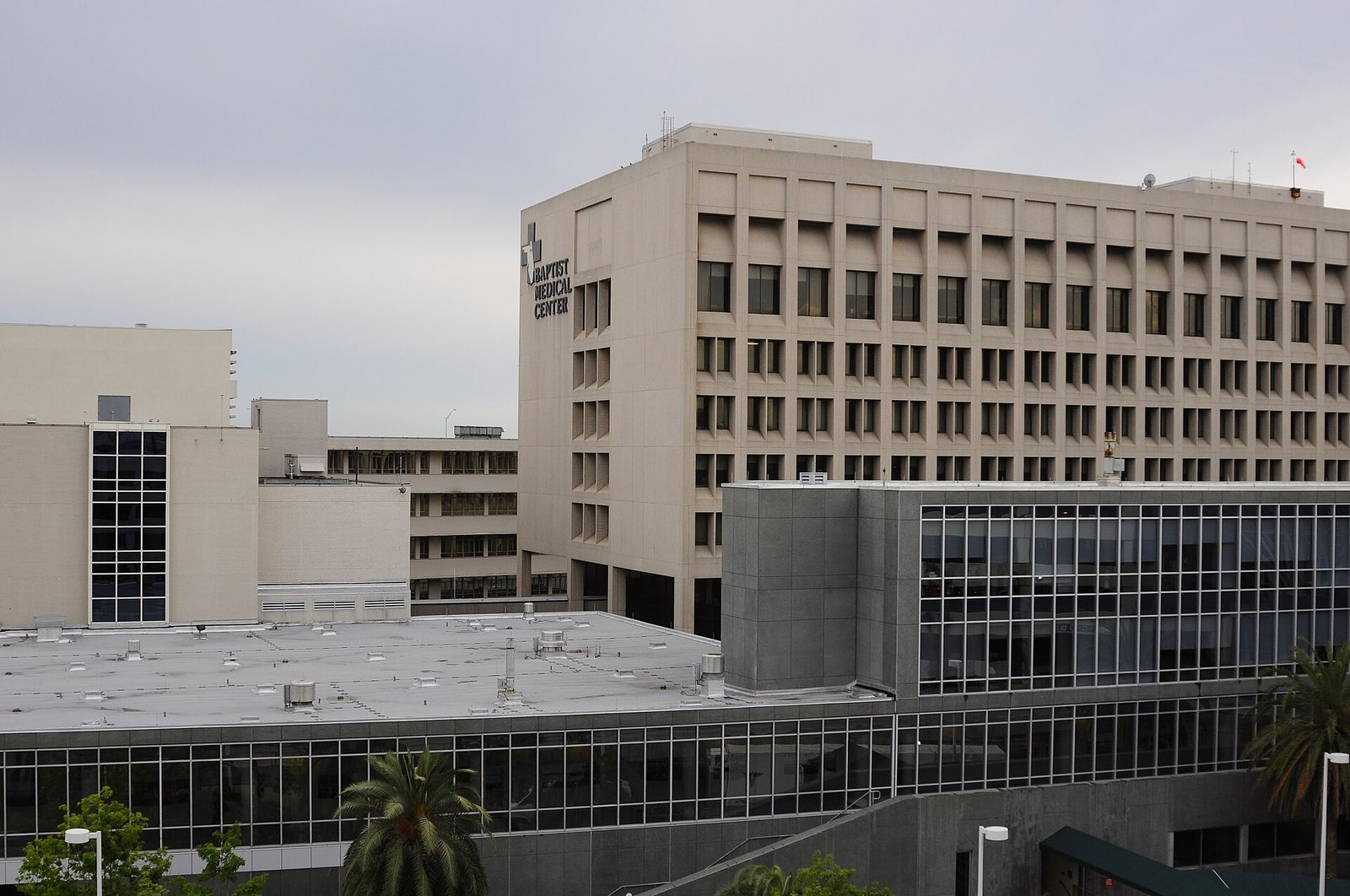 Tan high rise tower with a Baptist Medical Center sign above lower hospital buildings in Jacksonville, Florida