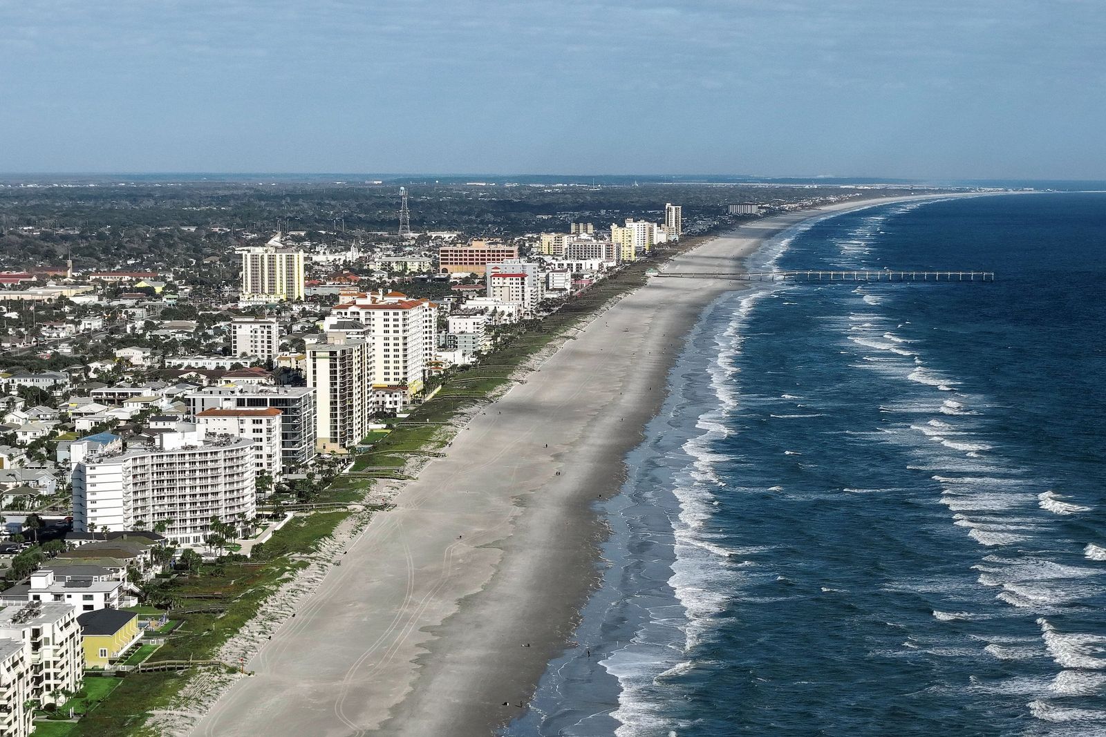 The Jacksonville Beach shoreline from the air, with the pier in the distance