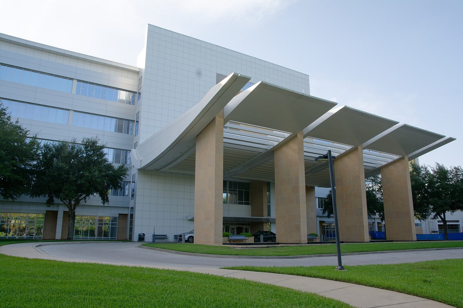 Curved white canopy and stone columns at a building entrance on the Mayo Clinic campus in Jacksonville, Florida