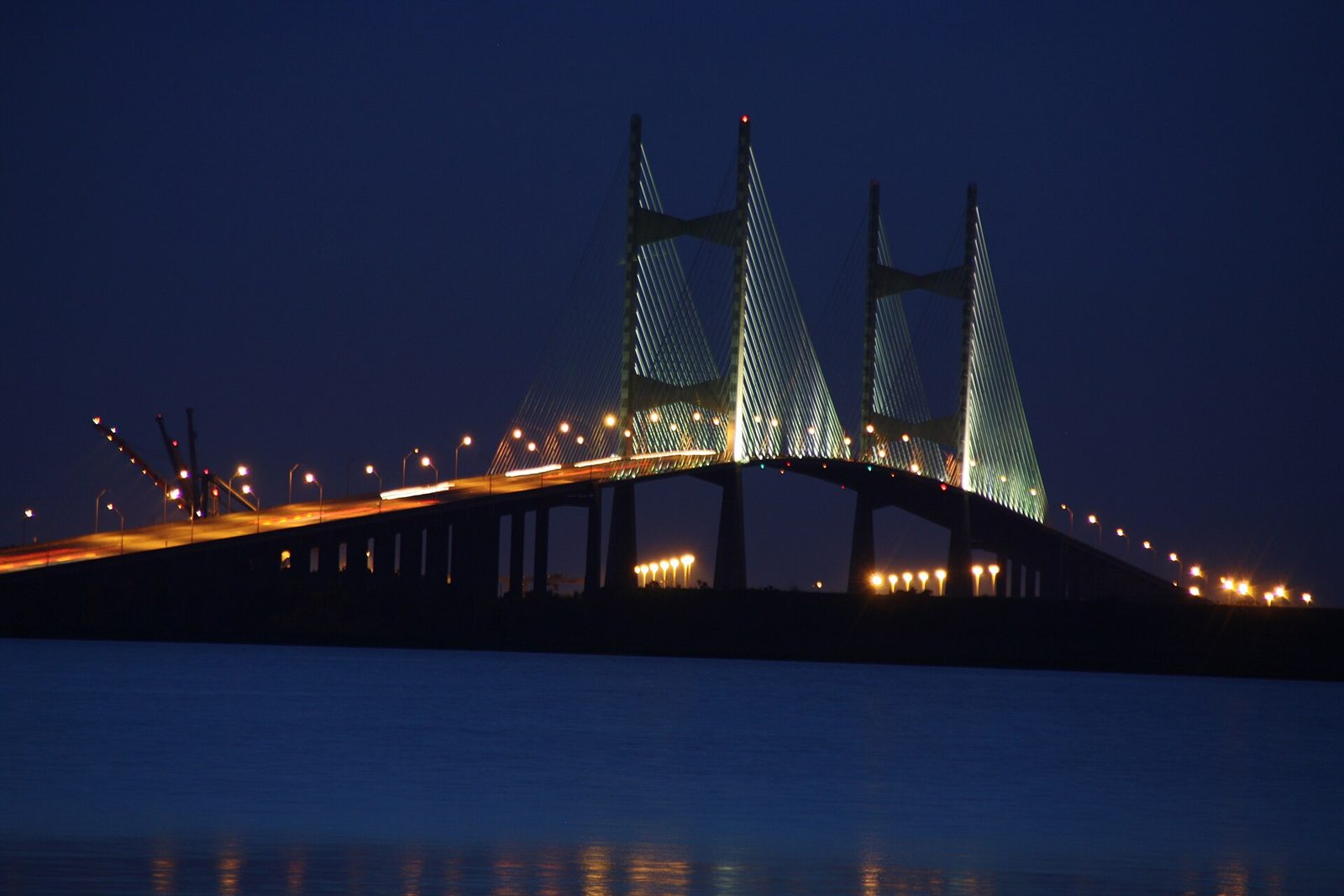 The Dames Point Bridge on I-295 lit up at night over the St. Johns River in Jacksonville, Florida