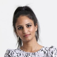 Headshot of Taniya Refai, REALTOR® and registered nurse, smiling